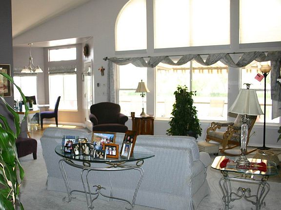 Living room with gas fireplace, vaulted ceiling and fabulous view of the lake 