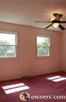 Master Bedroom with large Hunter remote-controlled ceiling fan