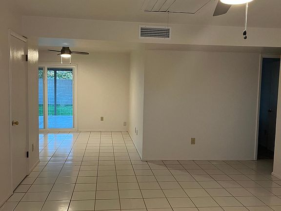Living room with view to dining and patio and back yard.