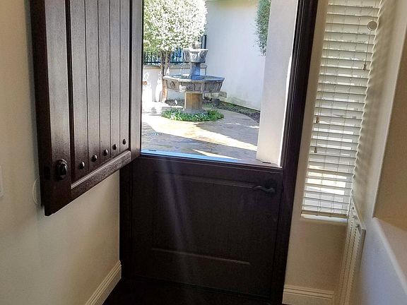 Inside look out into front courtyard. Enjoy the sounds of the soothing fountain as the breeze comes in thru the disappearing pull down screen on the front Dutch entry door.