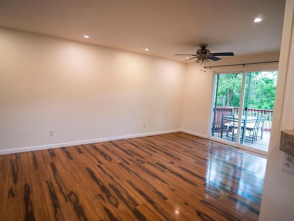 Living room area with sliding door to deck and backyard.