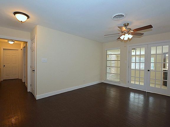 French glass doors open from the den into the sun room.