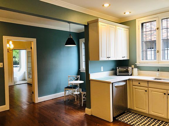 NEWLY UPDATED! Kitchen eating area with access to formal dining room and private screened in porch. All new paint and new light fixture with leather accents, beautiful original lead pained windows (with screens and storm windows based on season.)