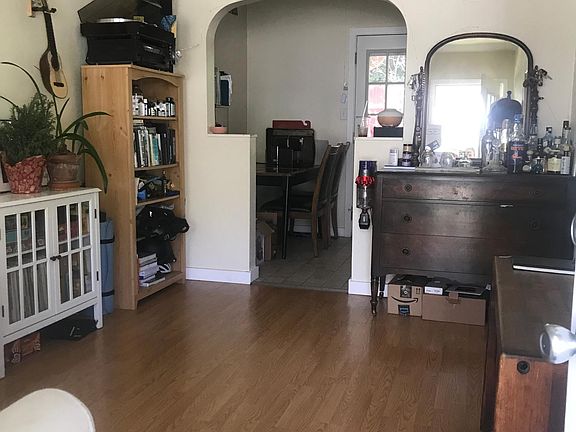 Living room. Delightful archway leads to kitchen and private patio area.