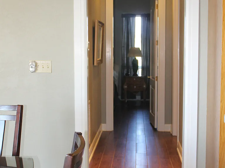 Hallway from living room and kitchen leads to 2 bedrooms and bath.