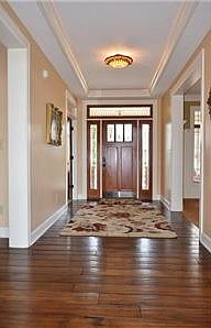 As soon as you enter the front door, you know you will notice the difference! Wide planked hand scraped hardwood floors, upgraded lighting, cove lighting, double thick walls, extensive custom trim details, 9 ft ceilings.  Large home but so warm and welcom