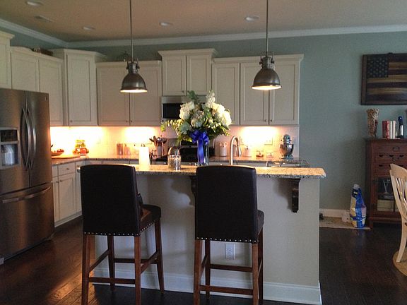 Kitchen and living room are painted Sherwin Williams Silvermist, a perfect gray blue green color depending on the light, it pairs well with all kitchen accent colors!