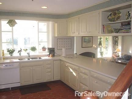 Kitchen
						:
						Quarry tile floor
Window above sink w/pretty view
Opens to Family Rm