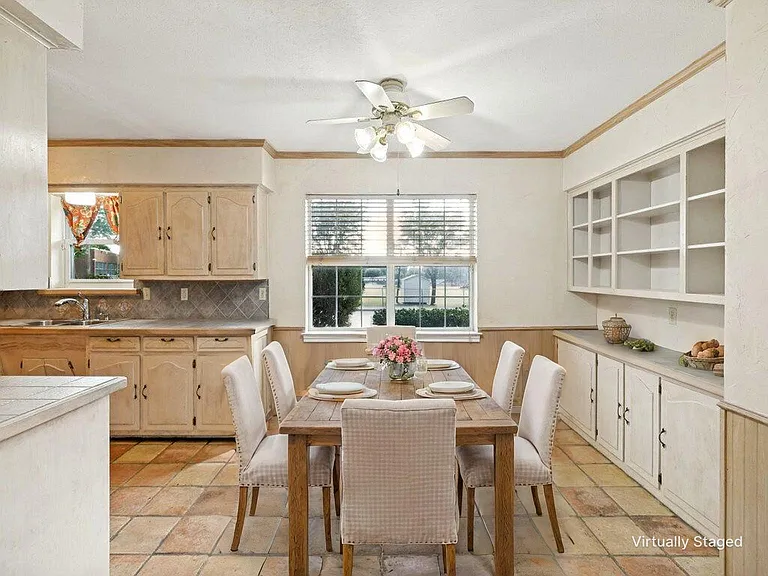 From the family room, you'll appreciate this well lit breakfast area that can accommodate a table for 8. Store all your favorites in the built-in cabinetry. Whether it's your morning coffee, or a gathering with friends, memories are made here.