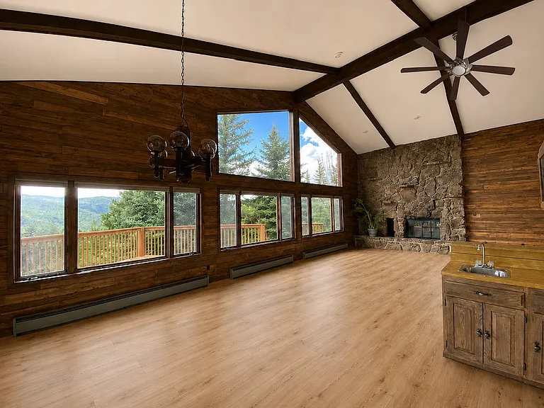 Open floor plan. Brand new Luxury Vinyl Plank flooring and new gas fireplace! Photo is digitally altered to show flooring and ceiling fan updates (original photos were taken prior to the floors and ceiling install).