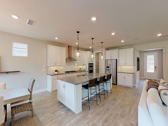 Model Representation Kitchen open to the gathering room with a large center island, great when host