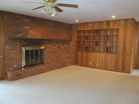 Den with fireplace and built-ins