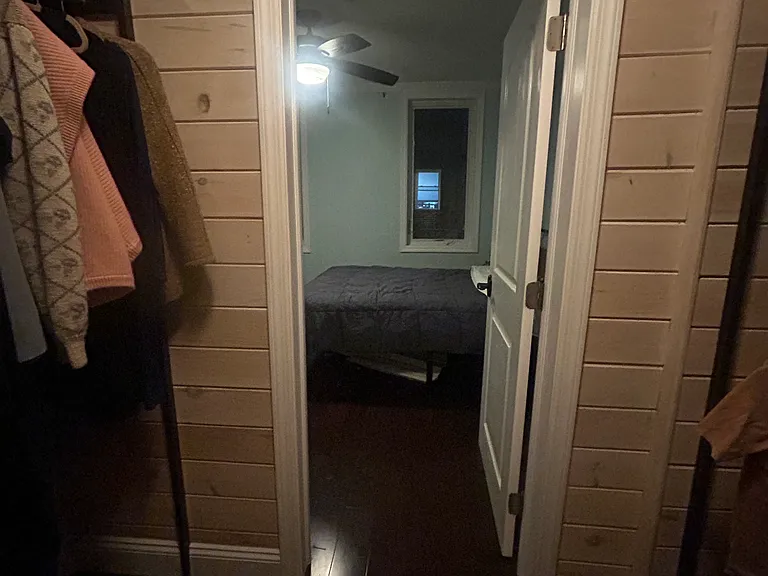 primary bedroom walk in closet with built in hanging and shelving space on both walls