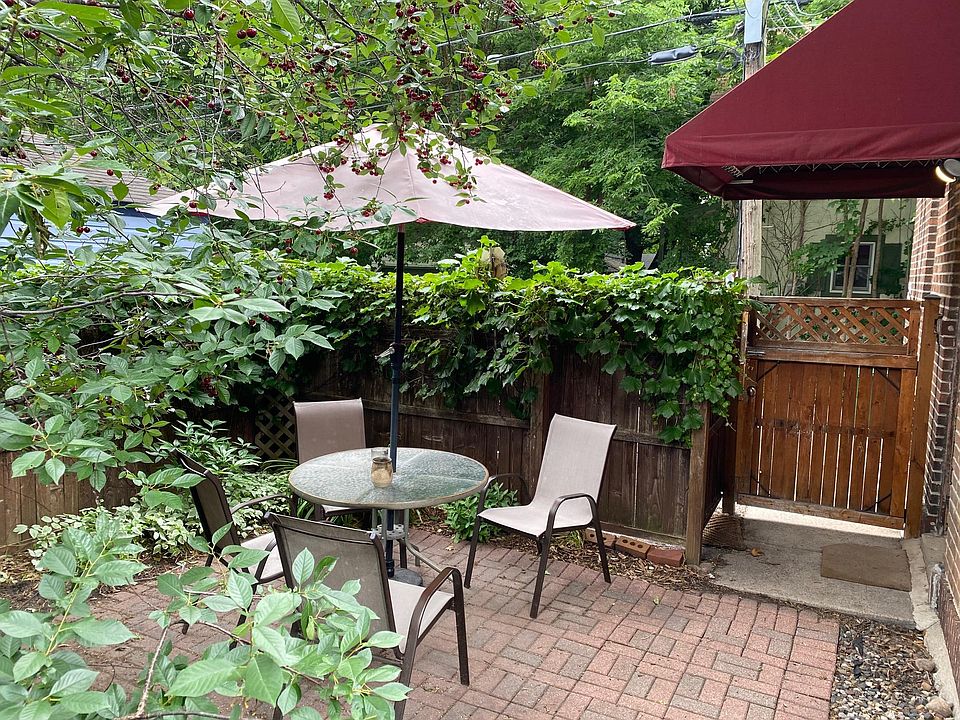 Private shared brick patio with southern exposure is nicely shaded but bright.