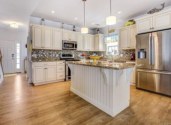 Kitchen with Granite and beautiful wide plank flooring.