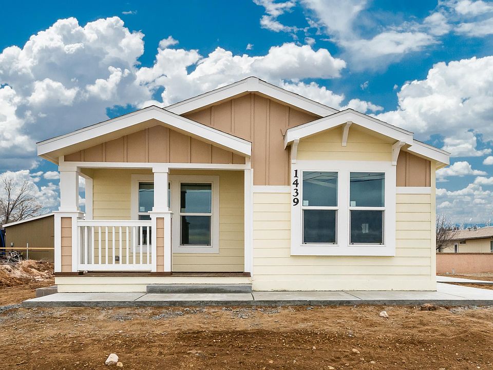 Front view - Nice front patio, over-sized Low-E vinyl windows, wide overhangs and accents, 2x6 construction, upgraded board & baton/lap concrete board siding, upgraded insulation.  Level ground set with concrete block stem wall.