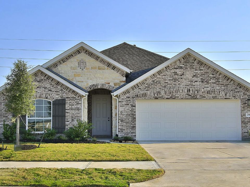 Experience luxury with arched entrances and classic brickwork in the exclusive Creekhaven community.