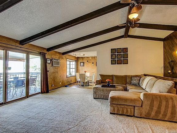 MAIN LEVEL GREAT ROOM. VAULTED CEILINGS. EXPOSED STAINED BEAMS.