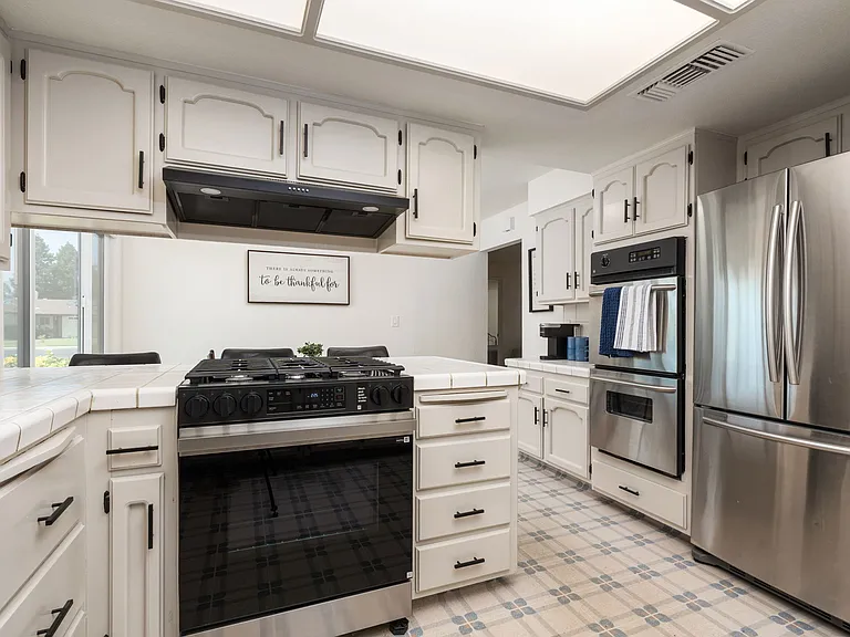 Fridge, stove, three ovens.