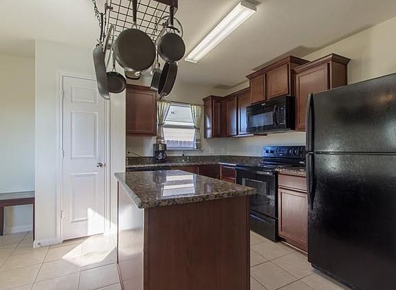 Granite counters, black appliances, and new black dishwasher