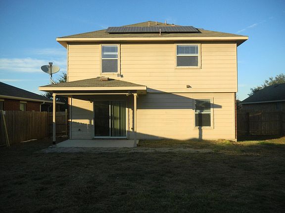 Back view showing solar panel, patio and satellite dish
