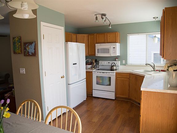 Kitchen with electric stove, large refrigerator, microwave, pantry, dishwasher and sink