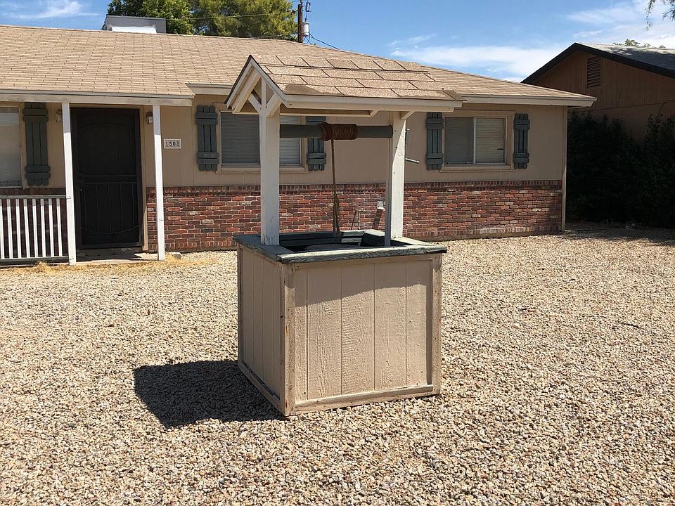 Front of house with decorative wishing well