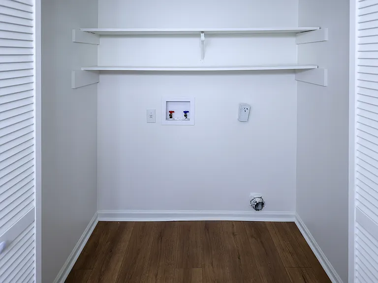Laundry area located behind louvered doors
