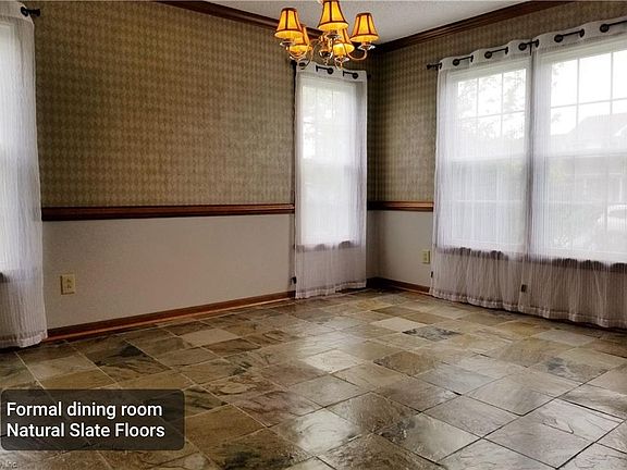Natural slate flooring on 1st floor. Hardwood flooring in kitchen. Spacious dining rm, living rm, plus large den.