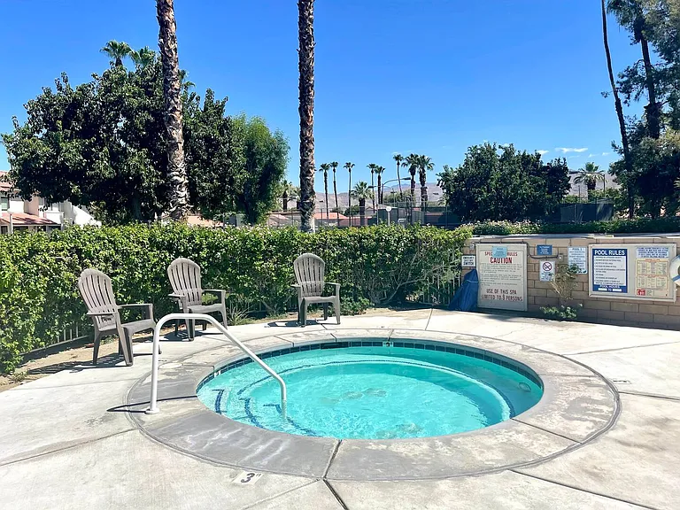 Hot tub is located in the main pool area.