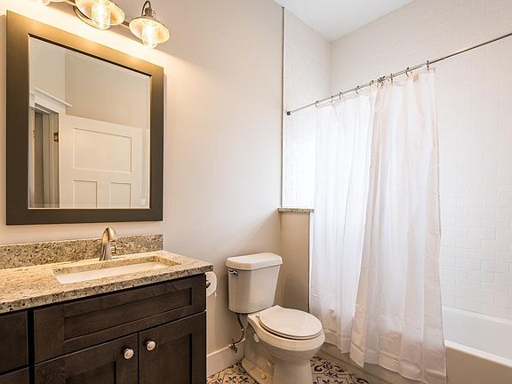 Full Bathroom 1 with tub and shower. Tile floor and tile surround