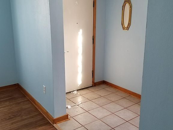 Living room looking at front door (tile entrance)