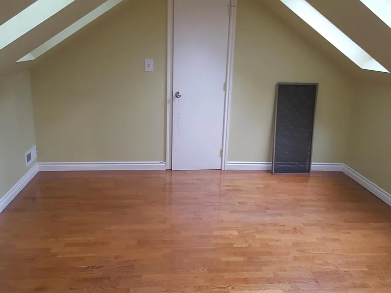 Upstairs bedroom with skylights and closet