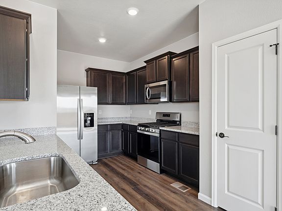 Upgraded kitchen with stainless appliances and granite countertops.