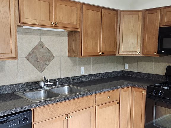Dishwasher, stove/oven, full size refrigerator in Kitchen with oak cabinets