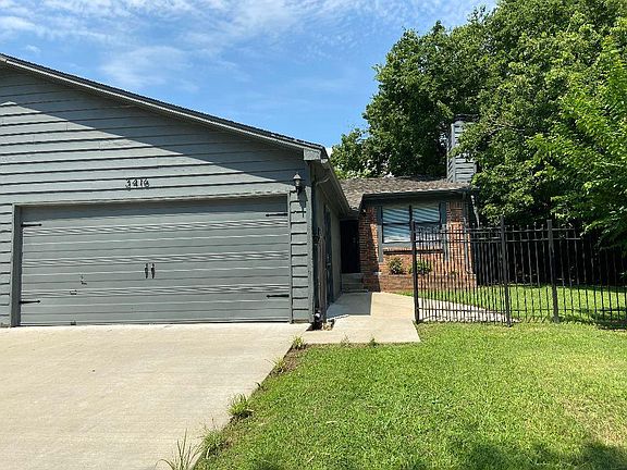 Front yard entry through the wrought iron exterior gate.