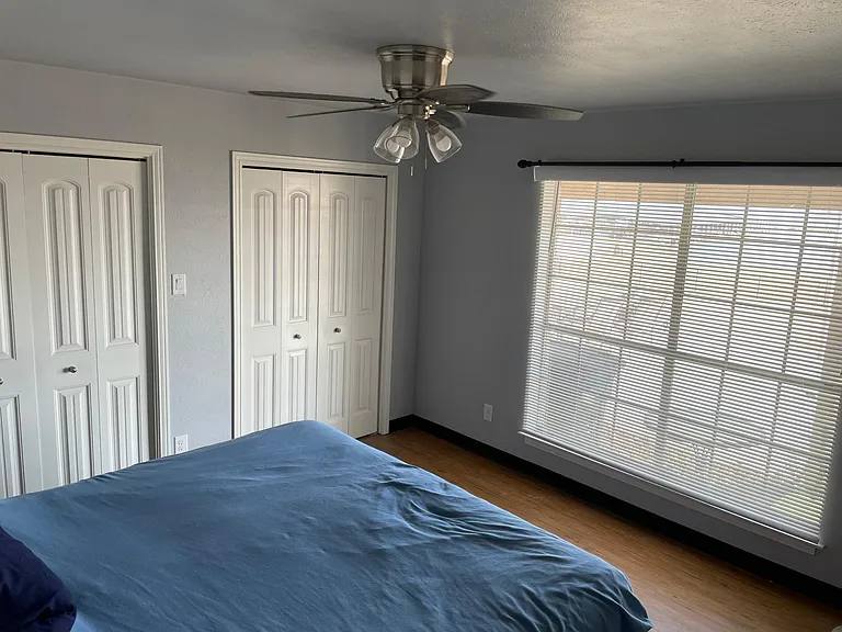 master bedroom with water view. Closets on both sides of room
