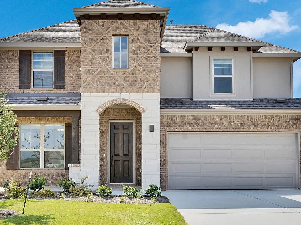 Luxurious brick facade with exquisite wood shutters in Rosewood at Briarwood. Beautifully landscaped