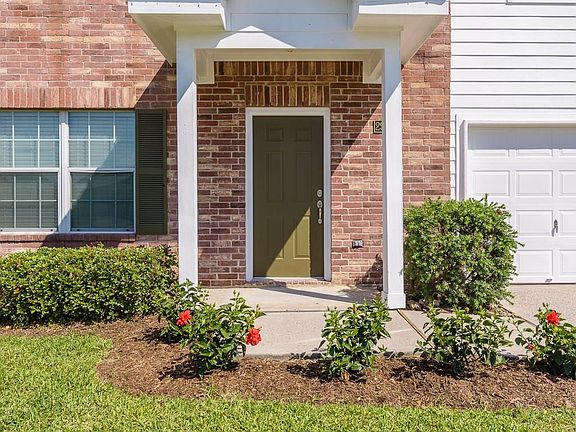 Enter the home under a covered front porch and surrounded by pretty landscaping.