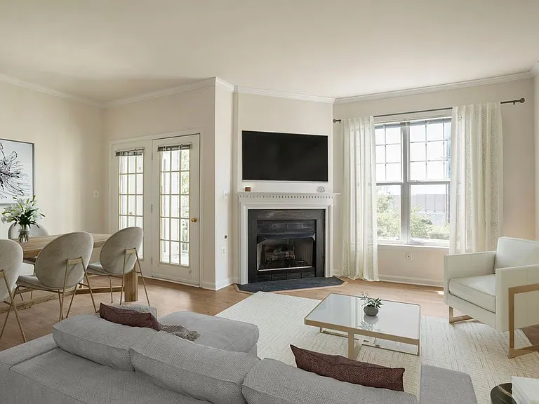 Renovated Package II living and dining area with fireplace and hard surface flooring