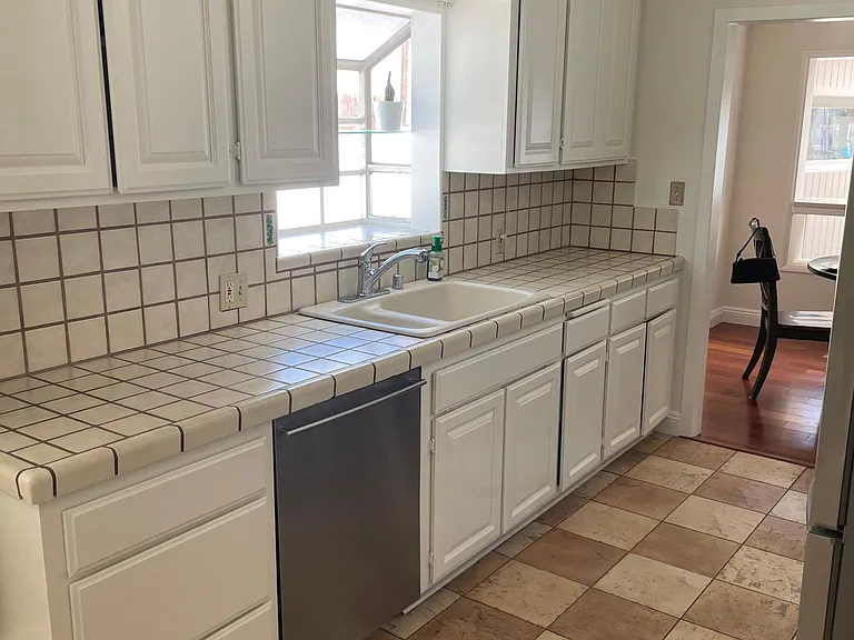 Kitchen, dishwasher, stove, microwave, refrigerator with laundry area
