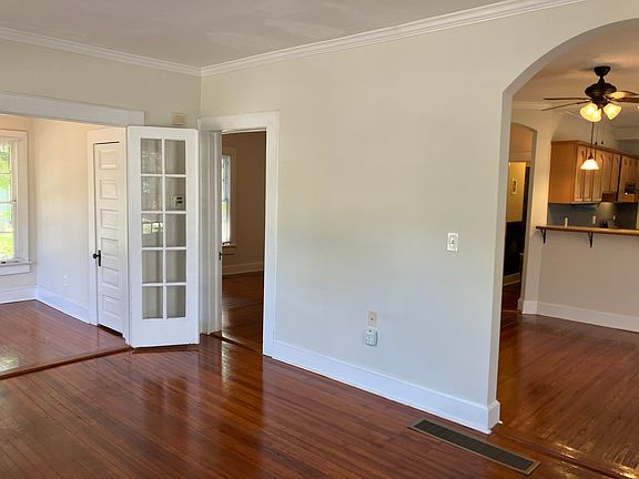 Living room. On the left front bedroom perfect for office or nursery. Middle door to the 2nd bedroom. On the right, dining room and kitchen.