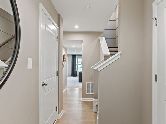 Bright and spacious hallway in a York II South Brook Townhome by DRB Homes, featuring modern design