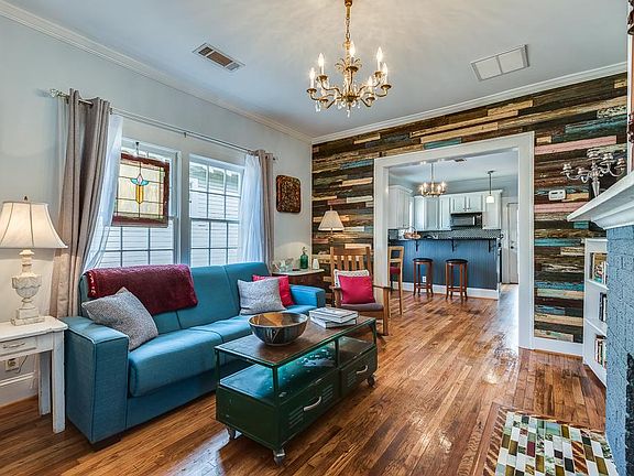 High ceilings, open concept, historic 120 year old reclaimed wood accent wall, mosiac historic crackle antique fireplace tiles.