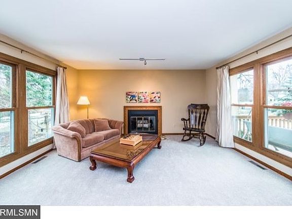 Living room with wood burning stove. Lots of daylight. Windows replaced in 2009 on main and upper levels of home. New paint and carpet in living room.