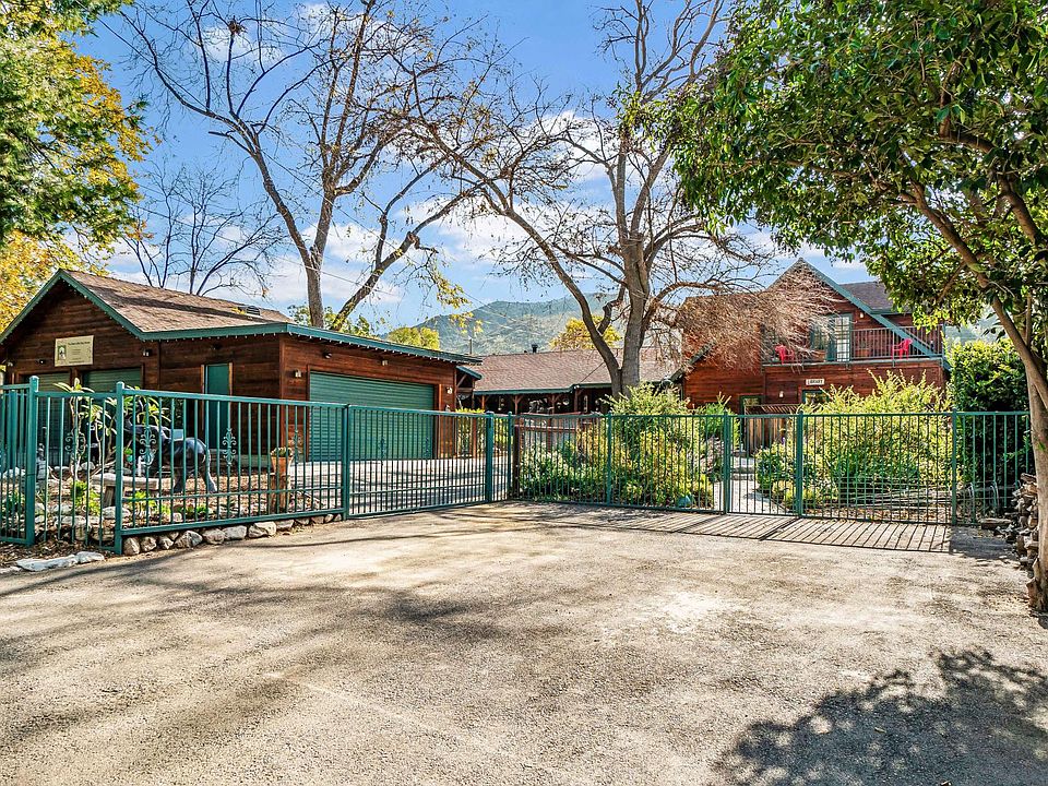 Paved parking area for your car and guest. The structure with double garage door and green side door is a finished 21 X 14 space, ideal for artist studio or storage.