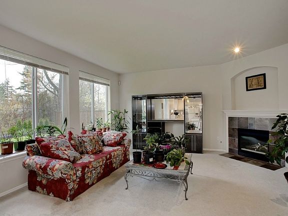 Family room off dining area has slate fireplace and oversized windows for natural light! Great for entertaining!