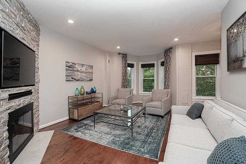 This residence is tastefully decorated featuring a functional wood burning fireplace, exposed brick, hardwood floors throughout, renovated kitchen, dishwasher, air conditioning and a main level washer and dryer.