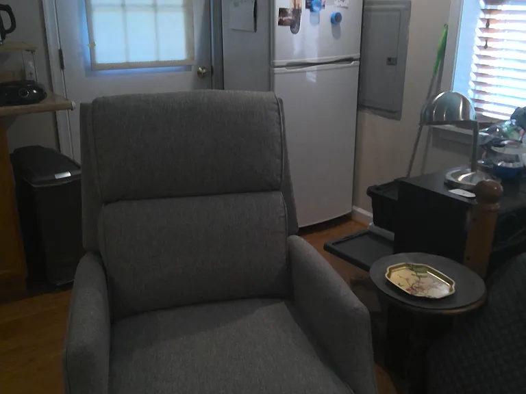 Entry door; bedroom area off to right; recliner is in living area.