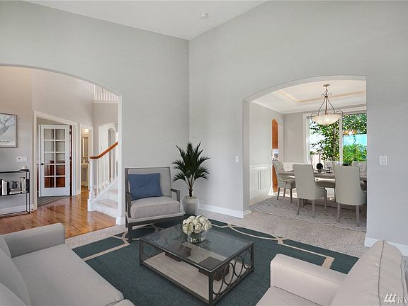 Formal Living and dining room with crown moulding and wainscoting. 